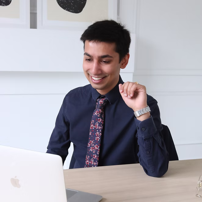 Naived Thaker smiling during a virtual therapy appointment consultation